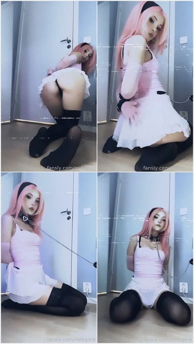 In a pink outfit with cat ears and cuffs, MilkGore ass plays into a cute petplay aesthetic in soft lighting.